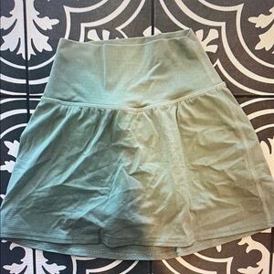 Never worn! Size 2 Lululemon green skirt with built in bike shorts